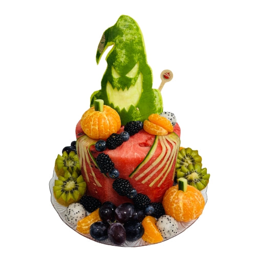 One-tier Halloween fruit cake with blackberries, blueberries, grapes, citrus and melon